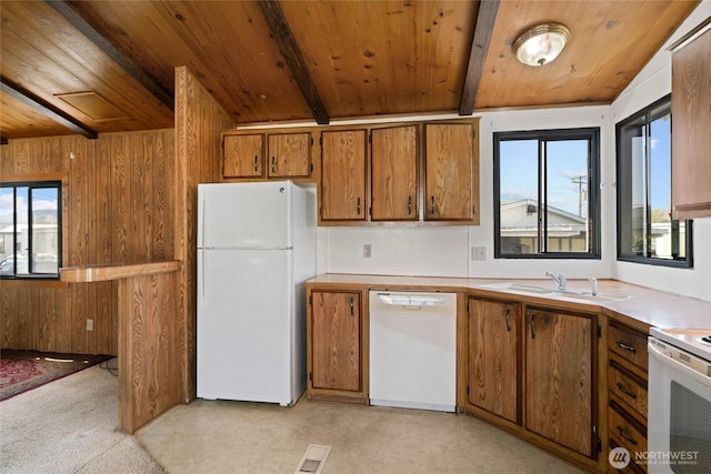 kitchen with visible vents, white appliances, brown cabinets, wooden ceiling, and a sink