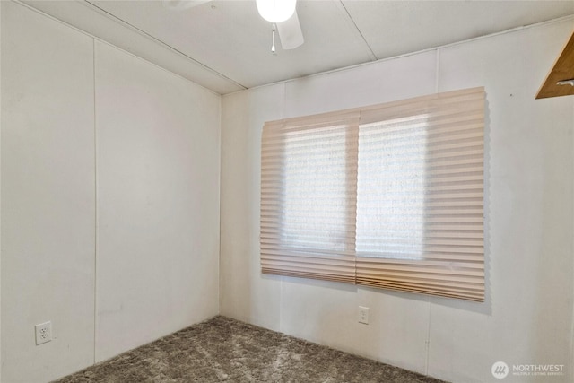 carpeted empty room with a ceiling fan