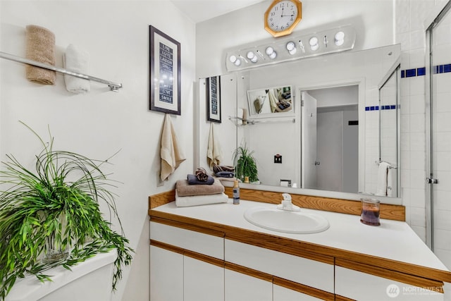 full bath with vanity and a stall shower