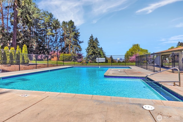 community pool featuring a patio and fence