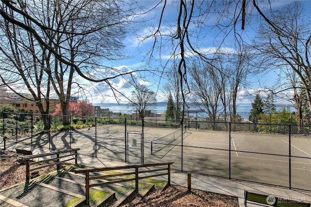 surrounding community featuring a tennis court and fence