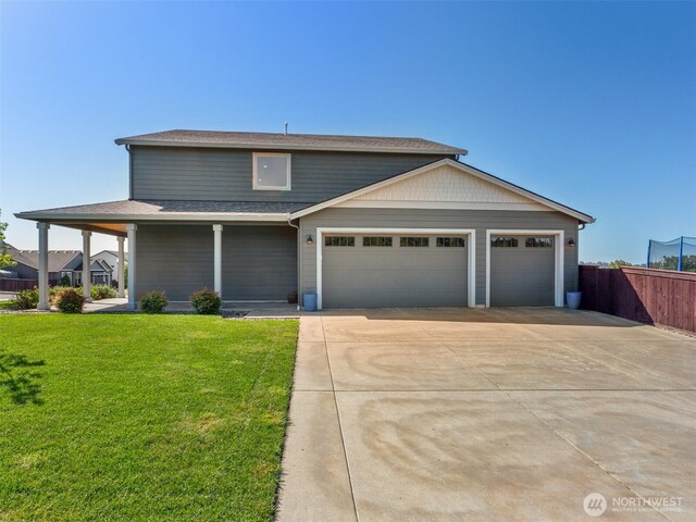 904 E Tanoak Ave, La Center, WA 98629 - view of front of house with concrete driveway, an attached garage, and roof with shingles