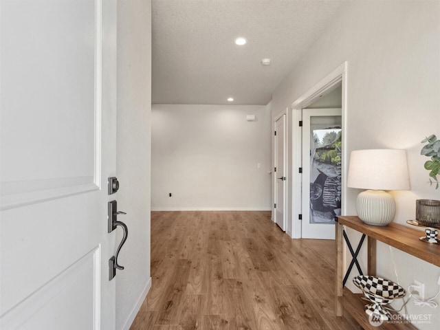 904 E Tanoak Ave, La Center, WA 98629 - hallway with wood finished floors, recessed lighting, baseboards, and a textured ceiling