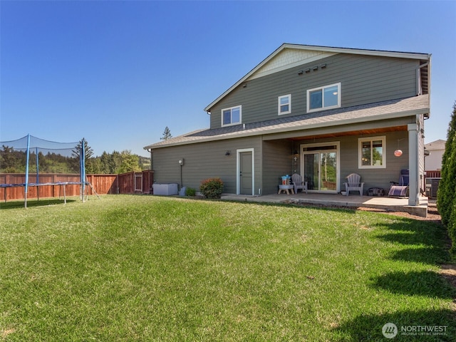 904 E Tanoak Ave, La Center, WA 98629 - back of property featuring a patio area, a trampoline, and roof with shingles