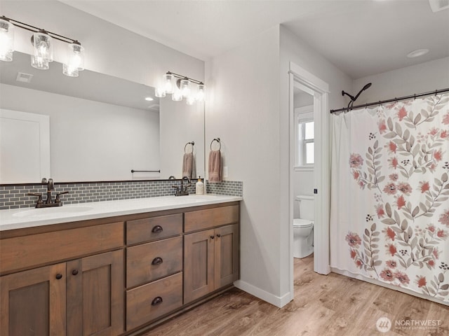 904 E Tanoak Ave, La Center, WA 98629 - full bath with wood finished floors, toilet, decorative backsplash, and double vanity