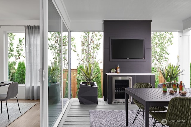 sunroom with beverage cooler and plenty of natural light