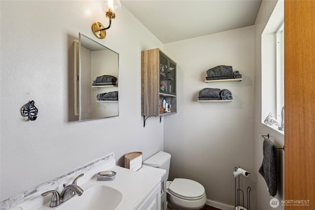 half bath featuring toilet and vanity