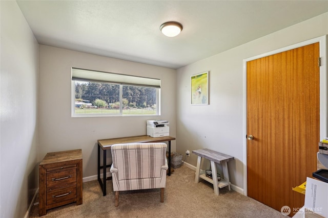 carpeted office featuring baseboards