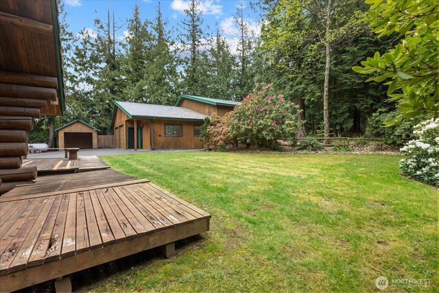 1321 E Smith Rd, Bellingham, WA 98226 - view of grassy yard featuring an outdoor structure, a wooden deck, and a detached garage