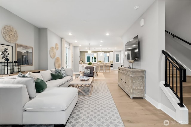 living room with recessed lighting and light wood-style floors