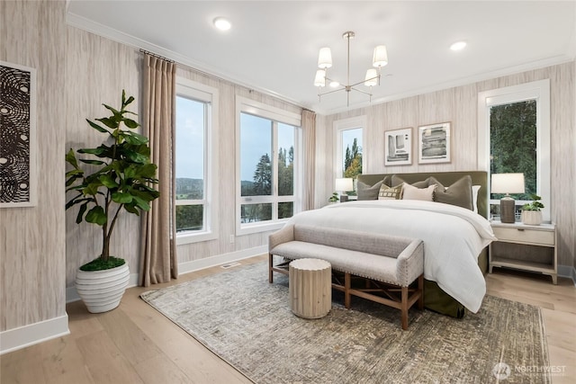 bedroom featuring ornamental molding, multiple windows, and a chandelier