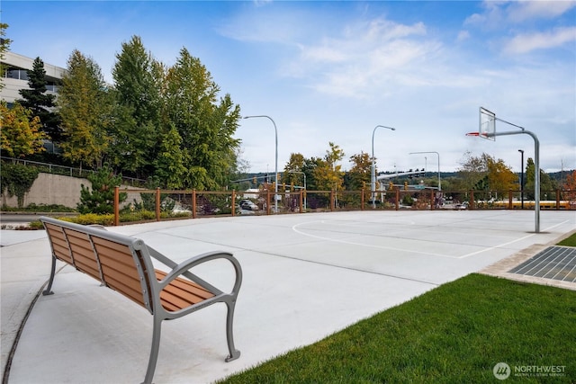 view of basketball court with fence and community basketball court