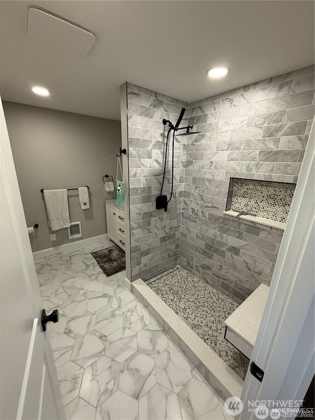 bathroom with visible vents, a tile shower, recessed lighting, and marble finish floor
