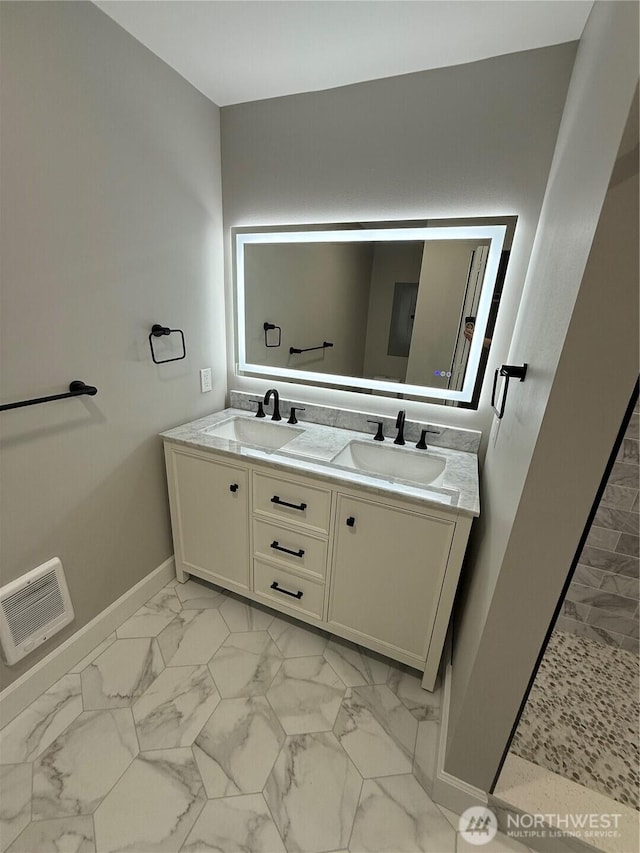 bathroom featuring visible vents, a sink, marble finish floor, and double vanity