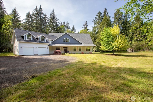 view of front of property featuring a porch, a front yard, a storage shed, an outbuilding, and aphalt driveway