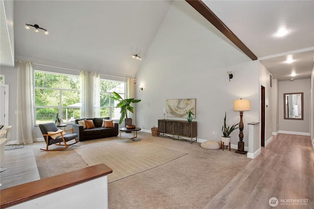 living room with light wood-type flooring, baseboards, beamed ceiling, and high vaulted ceiling