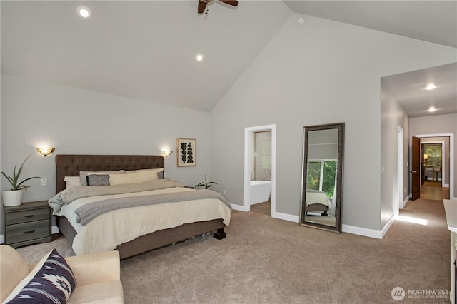 bedroom featuring high vaulted ceiling, baseboards, ensuite bath, and light colored carpet