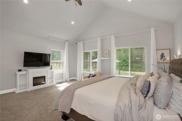 carpeted bedroom featuring recessed lighting, baseboards, a glass covered fireplace, and high vaulted ceiling