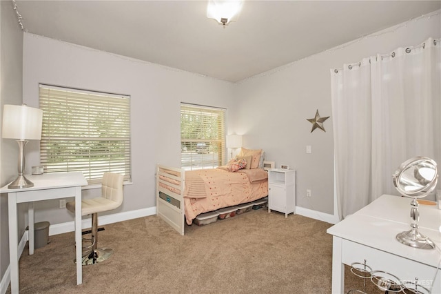 bedroom with light colored carpet and baseboards