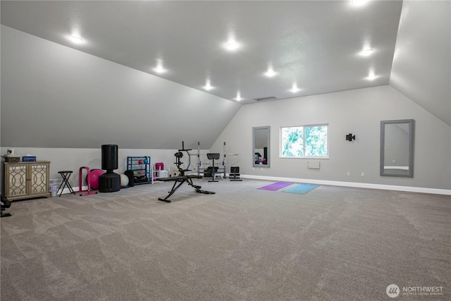 workout area featuring carpet floors, baseboards, and vaulted ceiling