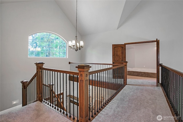 stairs featuring an inviting chandelier, high vaulted ceiling, and carpet