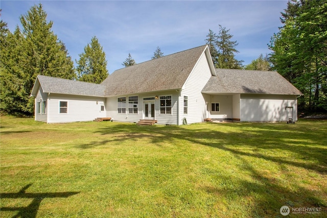 rear view of property featuring a lawn, roof with shingles, french doors, and entry steps