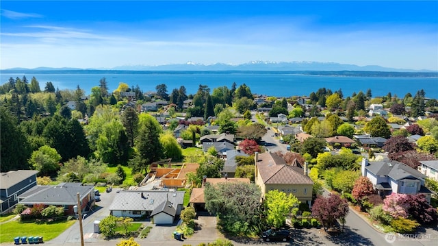 birds eye view of property with a water and mountain view and a residential view