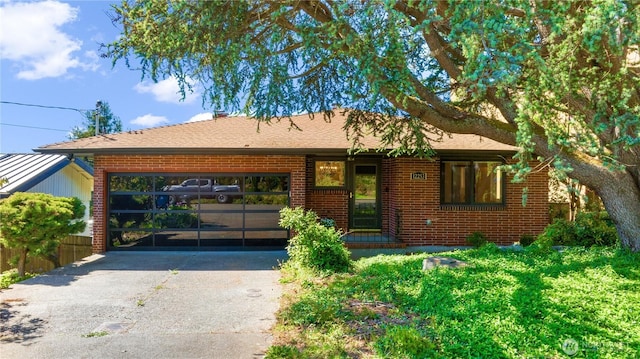 ranch-style house featuring brick siding and driveway
