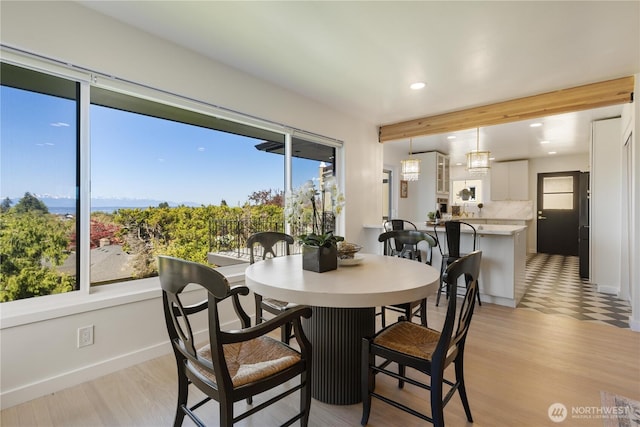 dining space with recessed lighting, baseboards, and light wood-type flooring