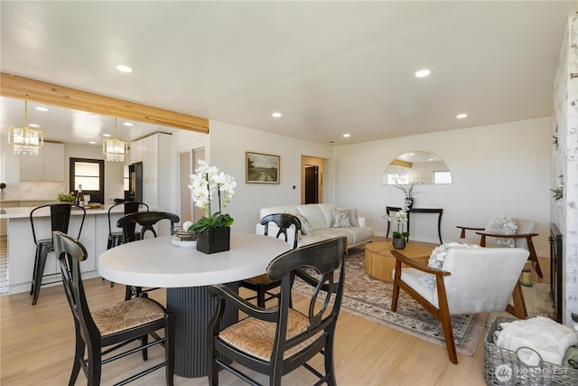 dining room with recessed lighting and light wood-style flooring