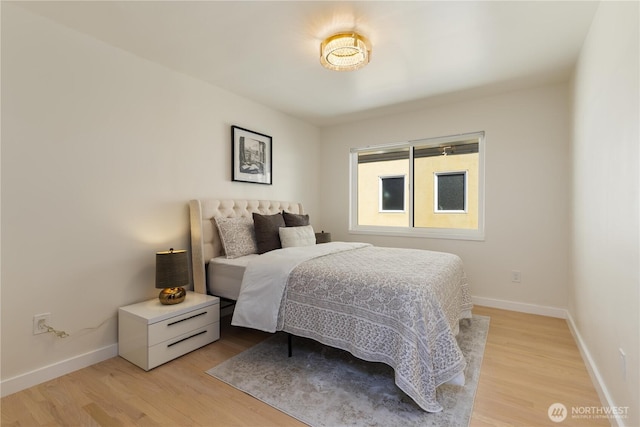 bedroom featuring baseboards and light wood-style floors