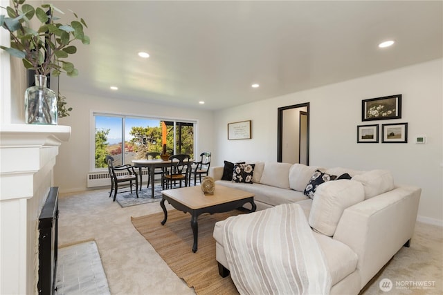 living room with light colored carpet, recessed lighting, and a baseboard radiator