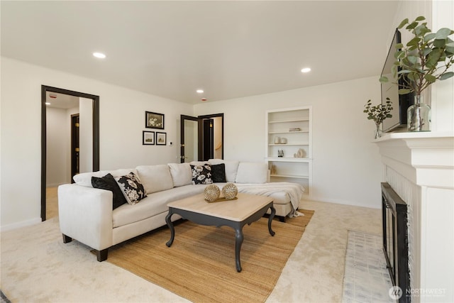 living area featuring built in features, light carpet, a brick fireplace, and recessed lighting