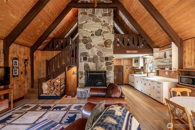 2684 Cedar Crst, Leavenworth, WA 98826 - living area with light wood-style flooring, wood ceiling, beam ceiling, stairs, and a stone fireplace
