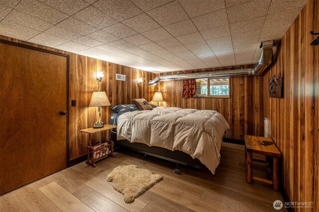 2684 Cedar Crst, Leavenworth, WA 98826 - bedroom featuring wood walls, wood-type flooring, and radiator heating unit