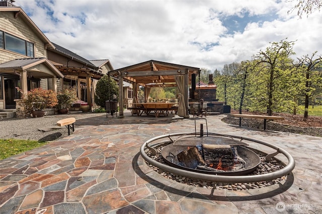 view of patio with a gazebo and a fire pit