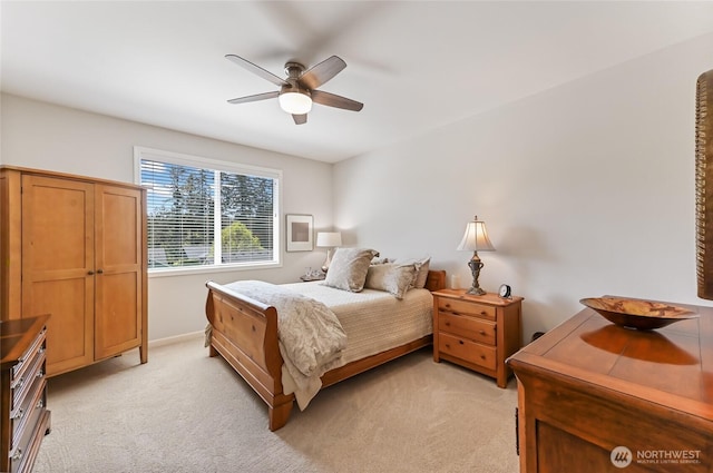 bedroom featuring light carpet, baseboards, and a ceiling fan