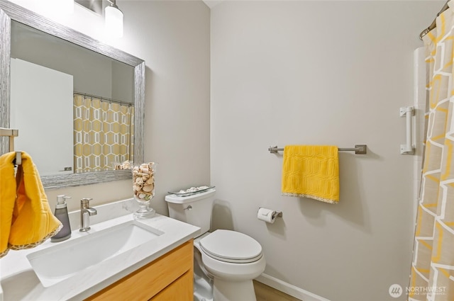 full bath with curtained shower, vanity, toilet, and baseboards