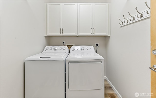 laundry room with cabinet space, washer and clothes dryer, visible vents, and baseboards