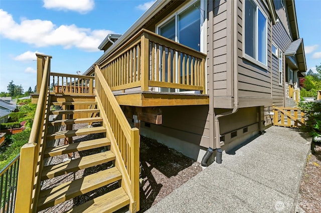 exterior space with stairway, a deck, and crawl space
