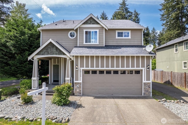 view of front of home featuring stone siding, board and batten siding, covered porch, and fence