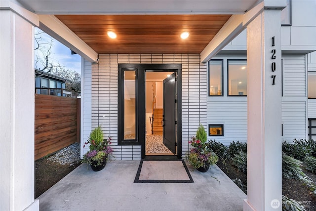 property entrance featuring fence and a patio area