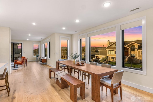 dining room with baseboards, visible vents, and light wood-style flooring