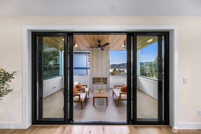 doorway to outside with baseboards and wood finished floors