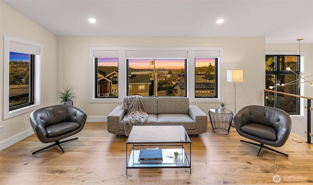 living area featuring baseboards, recessed lighting, and wood finished floors