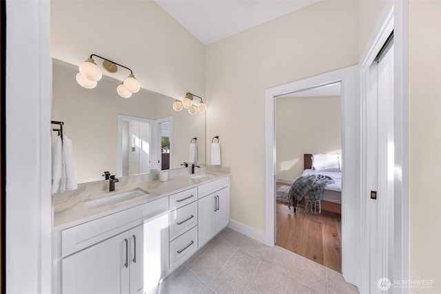 full bathroom with a sink, tile patterned floors, ensuite bath, and double vanity