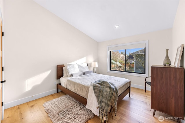 bedroom with baseboards, recessed lighting, light wood finished floors, and vaulted ceiling