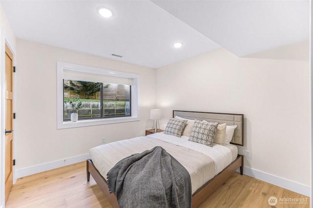 bedroom with baseboards, recessed lighting, light wood-style flooring, and visible vents