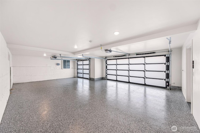 garage with a garage door opener and recessed lighting
