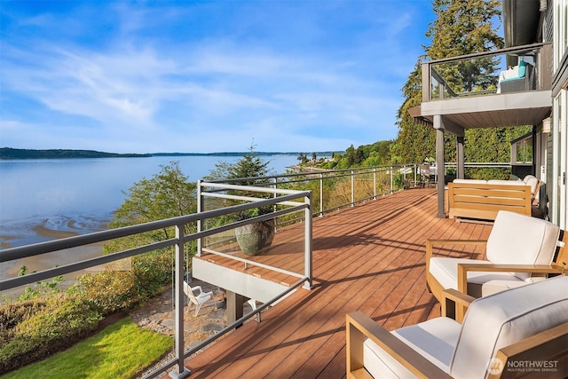 wooden terrace featuring a water view